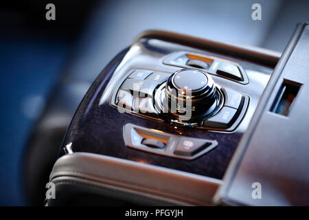 Control unit of stereo media system with telephone CD radio navigation for rear passengers in contemporary luxury car. Element of interior of expensiv Stock Photo