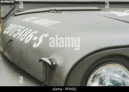 Close-up view of a Korean War era US Army Jeep showing its serial number on the hood. Fully restored to working condition, seen with fresh paint. Stock Photo