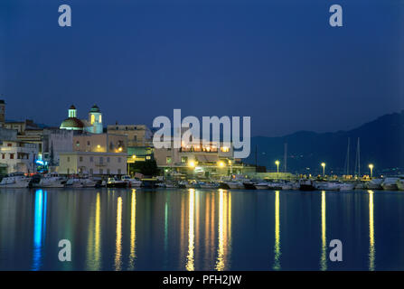 Italy, Campania, Bay of Naples, Torre del Greco, buildings overlooking marina, illuminated at night Stock Photo
