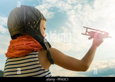 Child playing with wooden plane Stock Photo - Alamy