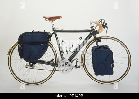 Touring bike with bottles attached to the frame and bags on front