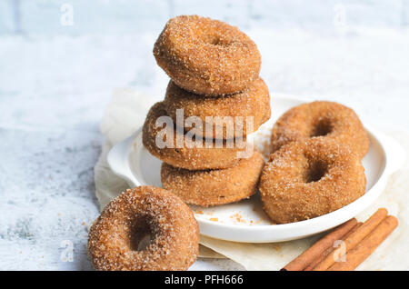 Cinnamon Donuts, Freshly Baked Homemade Doughnuts Covered in Sugar and Cinnamon Mixture, Stock Photo