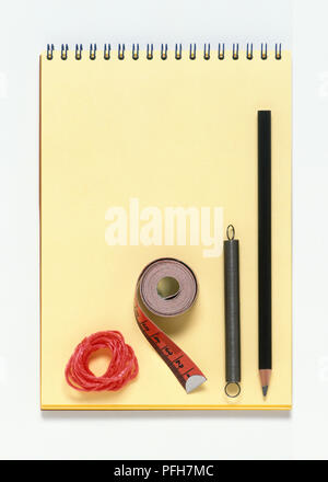 Notebook, pencil, spring, tape measure and string Stock Photo
