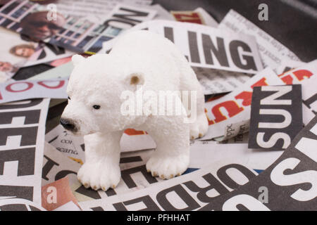 Polar bear on cut newspaper titles Stock Photo