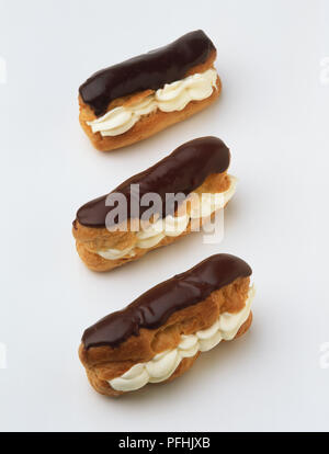 Three chocolate eclairs, close up. Stock Photo