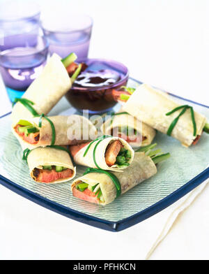 Duck rolls served with plum sauce on square tray, close up. Stock Photo