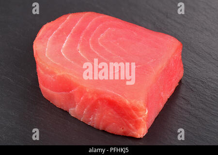 delicious Fresh raw tuna fish steak on dark slate tray, view from above, close-up Stock Photo