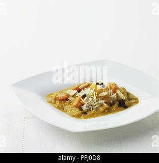 Vegetable curry served with basmati rice on square wide-rimmed plate Stock Photo