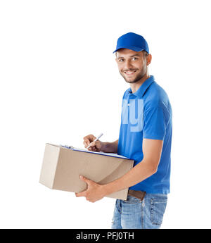 Portrait of courier fills paper on delivery box isolated on white background Stock Photo