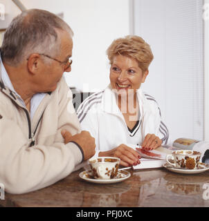 Mature couple looking at each other drinking tea Stock Photo