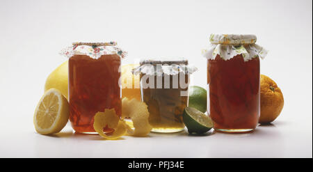 Three jars of marmalade and fresh fruit Stock Photo