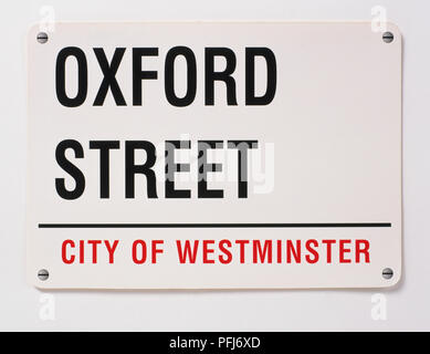Great Britain, England, London, black and white street name sign for Oxford Street, with 'City of Westminster' printed below in red, close up. Stock Photo