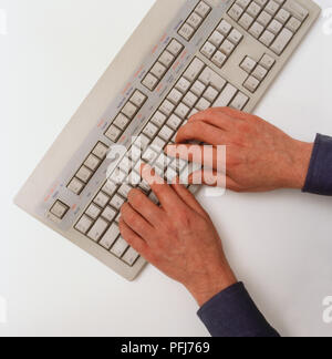Hands typing on computer keyboard, view from above. Stock Photo
