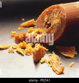 Block of palm sugar, some pieces broken off. Stock Photo