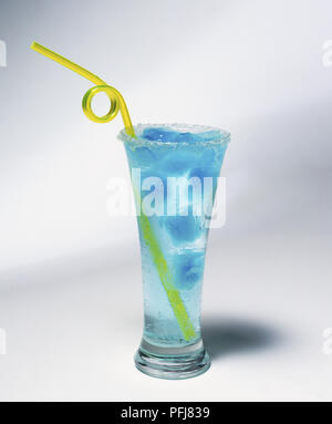 Tall glass of water with blue ice cubes and a curly yellow plastic straw Stock Photo