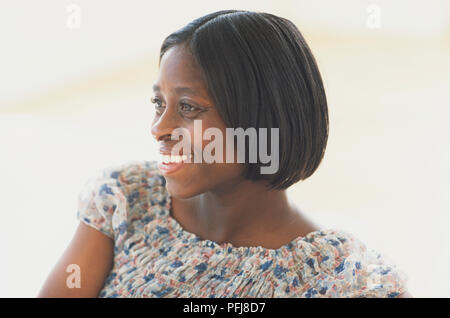 Smiling woman in summery top, side view. Stock Photo