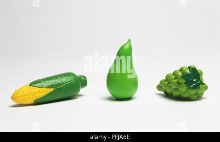 Plastic corn on the cob, pear and grapes Stock Photo