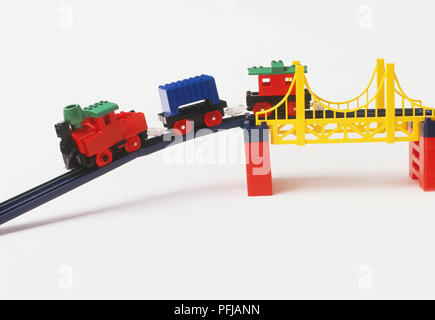 Toy train crossing a bridge Stock Photo