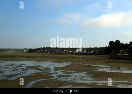 Beach and low tide with mist rolling in and view towards Troguerot from Promenade de Penarth, Vrennit, Saint Pol de Leon, Finistere, Brittany, France Stock Photo