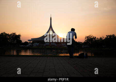 Male photographer taking picture architecture in public park at sunset time Stock Photo