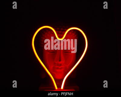 neon love heart buddha black background Stock Photo