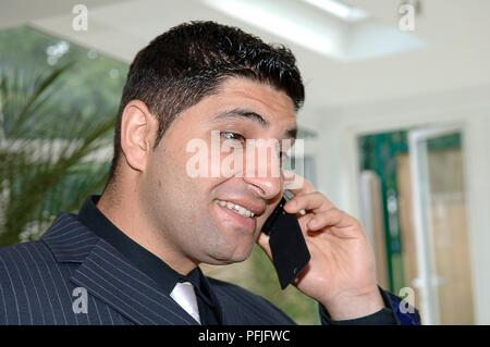 Headshot of businessman talking on the phone, close-up Stock Photo