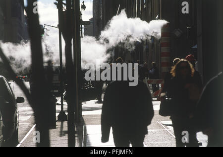 USA, New York, steam rising from pipe in busy street Stock Photo