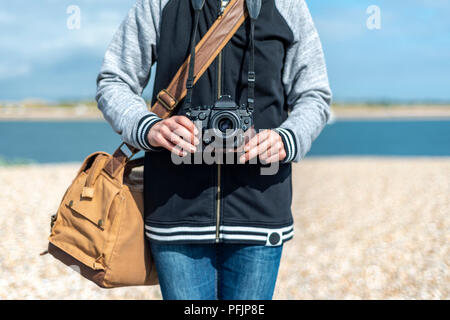 woman holding a retro camera. Close up, waist up. Stock Photo