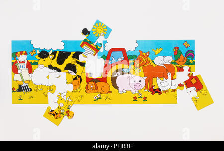 Almost-complete jigsaw puzzle forming cartoon picture of animals on farm Stock Photo