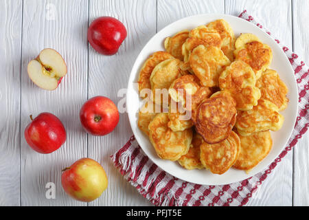 homemade Apple Greek Yogurt Pancakes - thick, fluffy and loaded with juicy pieces of fruits, on white plate with apples at background, view from above Stock Photo