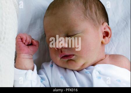 6-day-old baby boy lying asleep, close-up Stock Photo