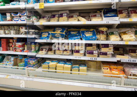 Cheese display (in plastic packaging)  in a Tesco supermarket, UK Stock Photo