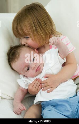 cute baby girl and boy kissing