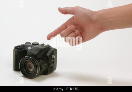 Man pointing at digital camera Stock Photo