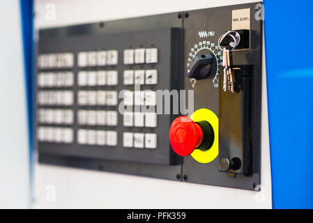 Red button on control panel of a factory machine Stock Photo