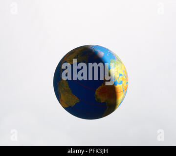 Model of planet Earth revolving on axis as shadow extends over northern hemisphere Stock Photo