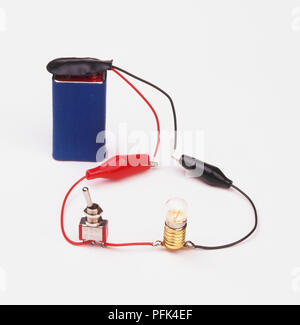 Light bulb in an electric circuit in a school science lab with students ...