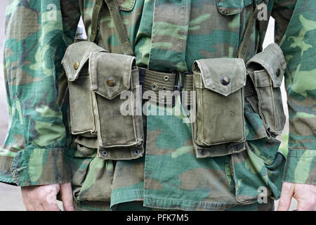 Man wearing Vietnam War US Marine uniform with ammunition belt, mid section, front view