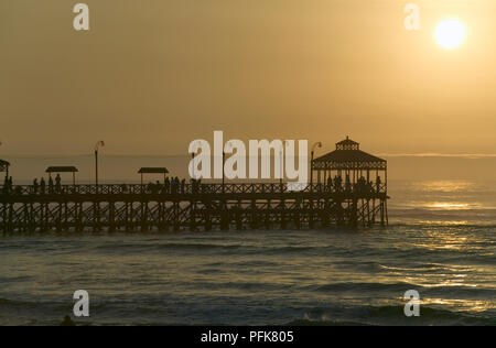 Peru, Huanchaco, sunset over pier Stock Photo