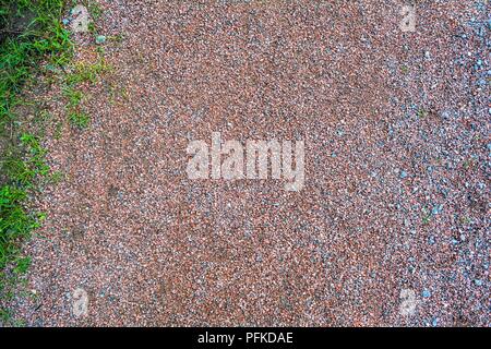 Brown texture of red granite Gravel. Sand and stones on the floor background. The ground is covered with stone fractions Stock Photo