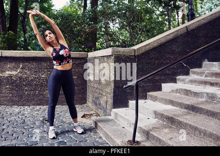 Latina Hispanic Woman Stretches Before A Workout Stock Photo