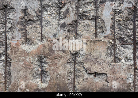 Broken concrete wall with iron grid Stock Photo