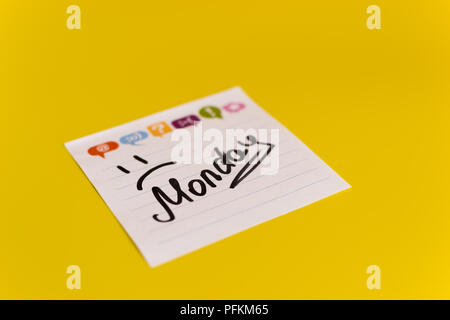 inscription in black marker Monday on the sticker yellow background Stock Photo