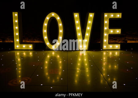 Illuminated Love sign in large letters at a wedding reception ready for the First Dance Stock Photo