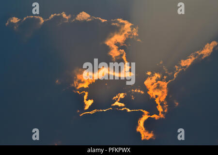 A cloud formation in Alberta Canada with a setting sun and  smoke from near by forest fires creating a surreal image in the sky. Stock Photo