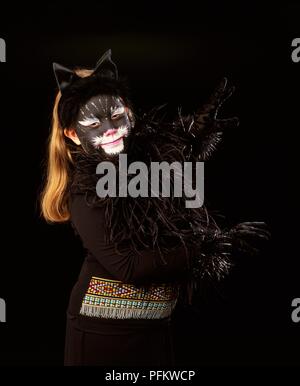 A young girl dressed up as a black cat. Stock Photo