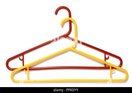 https://l450v.alamy.com/450v/pfkxyy/red-and-yellow-plastic-coat-hangers-one-on-top-of-the-other-pfkxyy.jpg