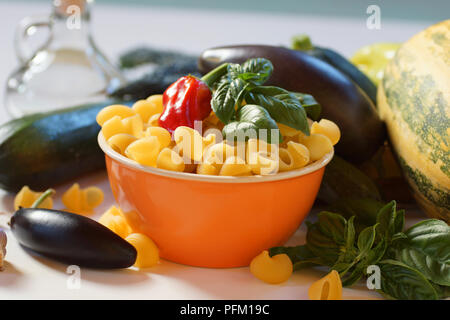 Ingredients for the preparation of Italian pasta. Still life of courgettes, patisson, eggplant, pepper, garlic and pasta. Stock Photo