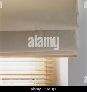 Double blinds at window, wooden blinds and textile blinds, close-up Stock Photo