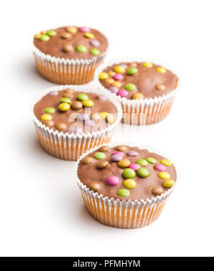 Sweet cupcakes with candies isolated on white background. Stock Photo